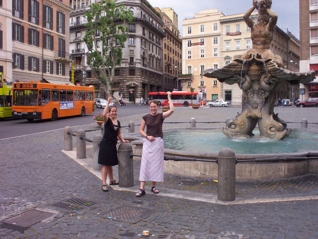 Throwing coins in a fountain in Rome