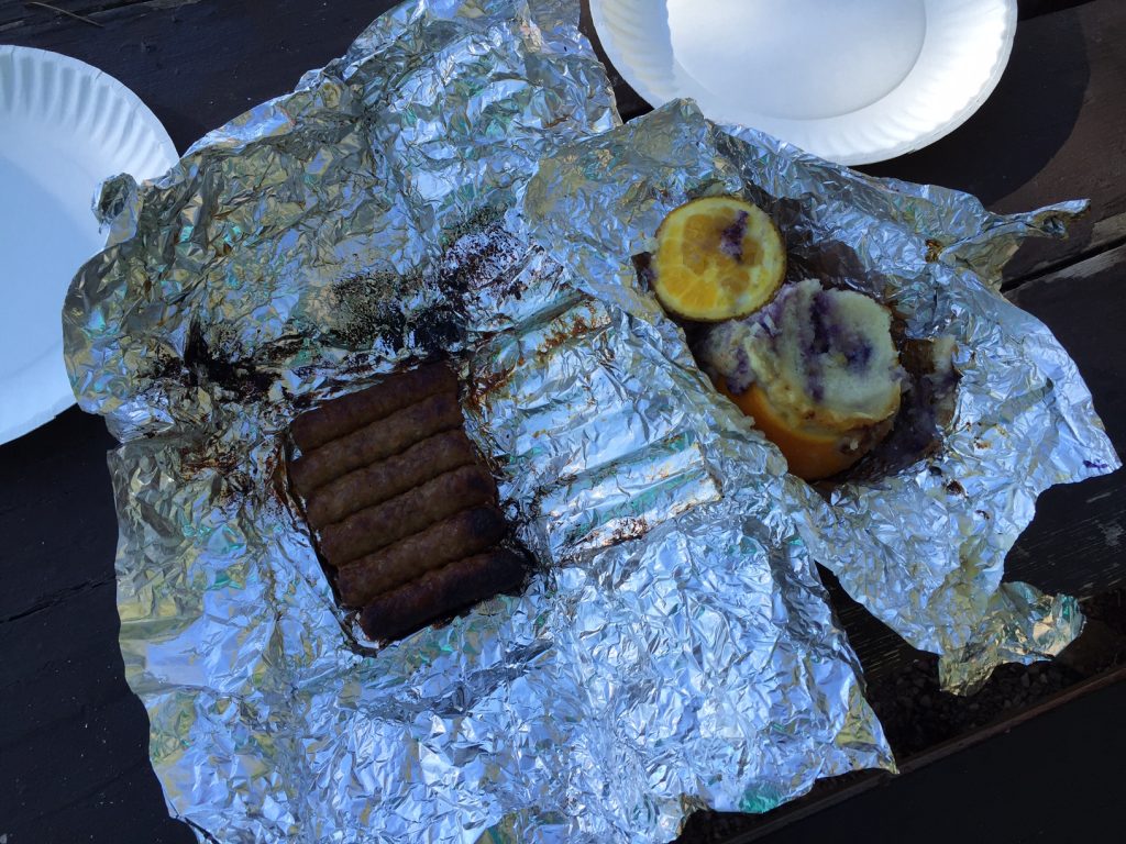 Blueberry Muffins baked over campfire in an orange