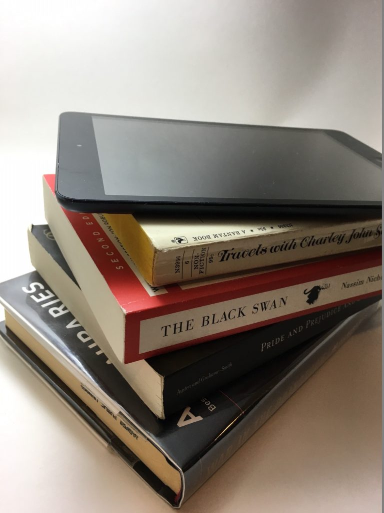 packing light tools, iPad mini on top of books