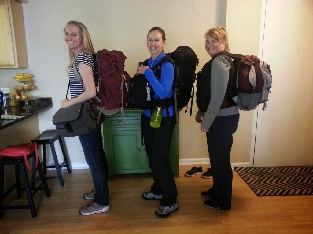 Three female travelers backpack friends vacation