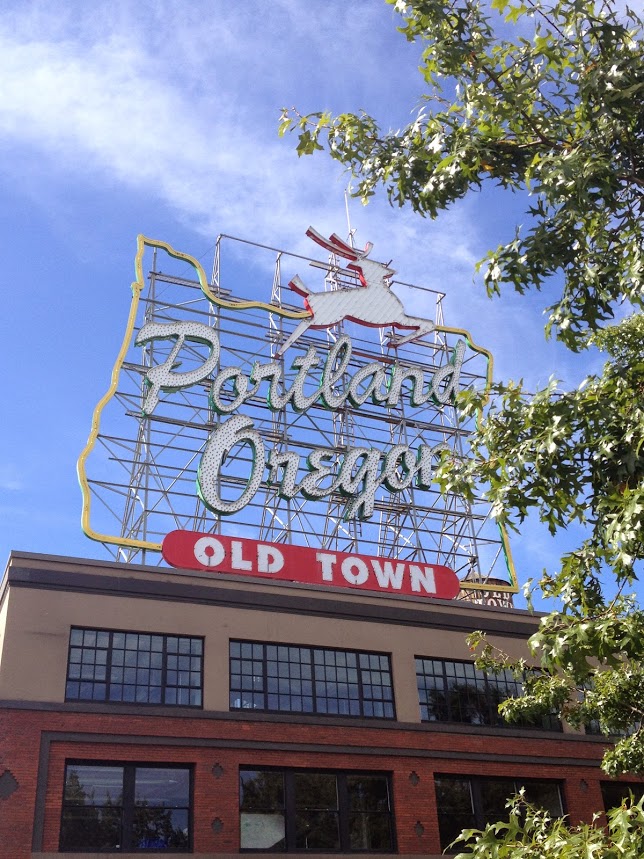 Portland Oregon Old Town sign blue skies packing for business travel work trip