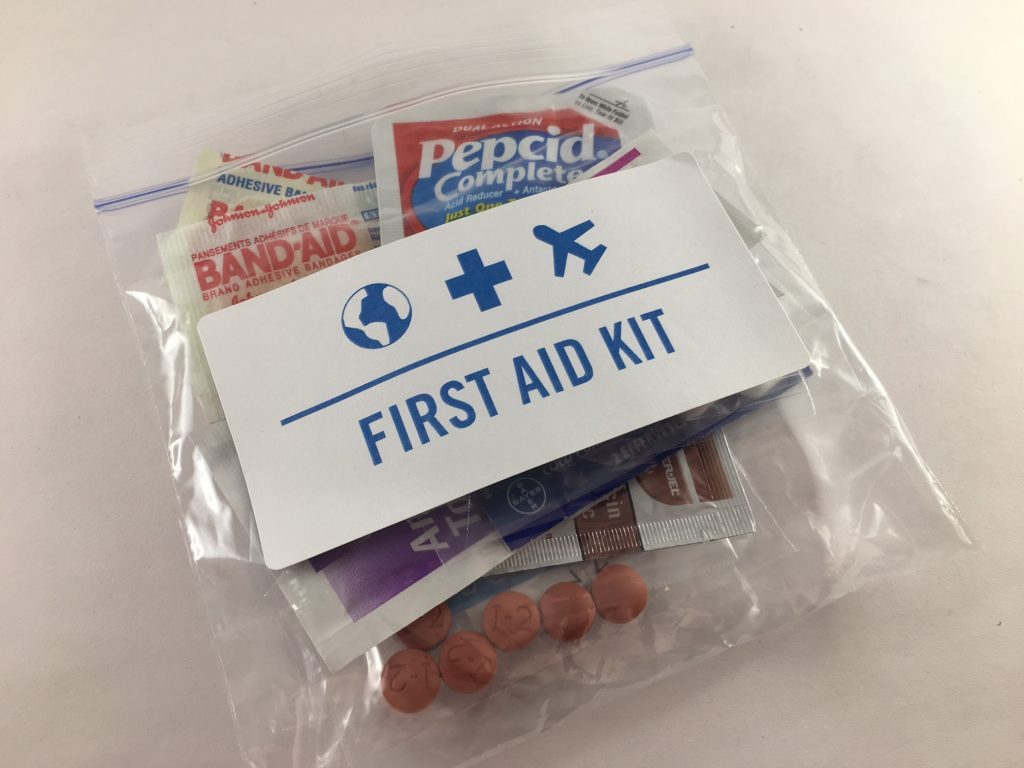 items for travel first aid kit in a plastic bag