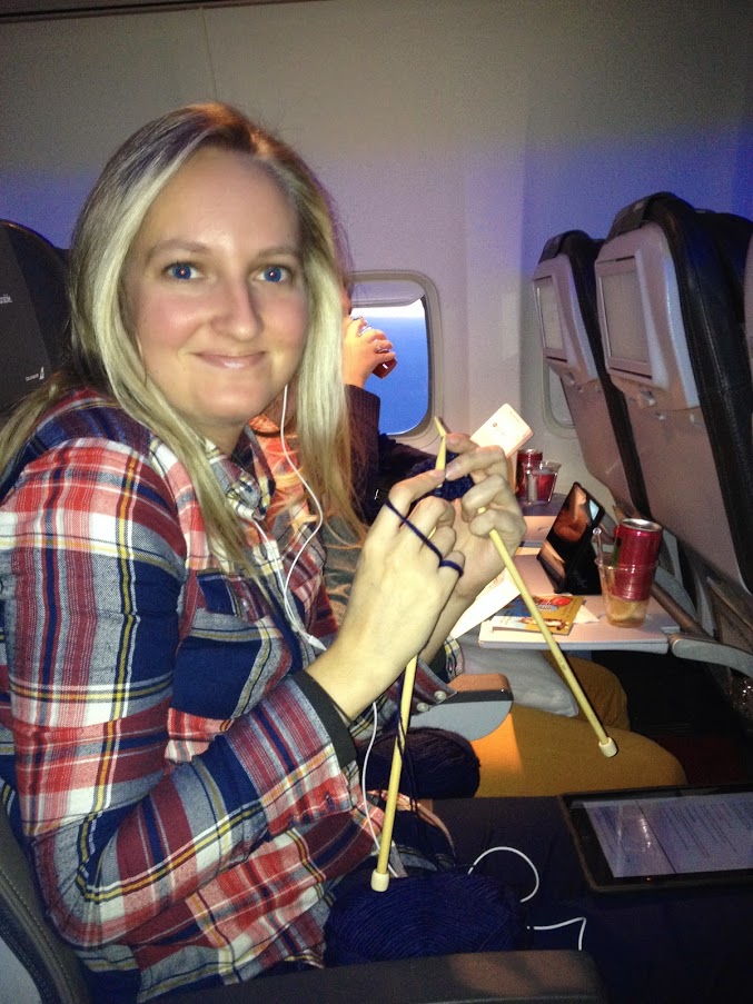 girl knitting on airplane