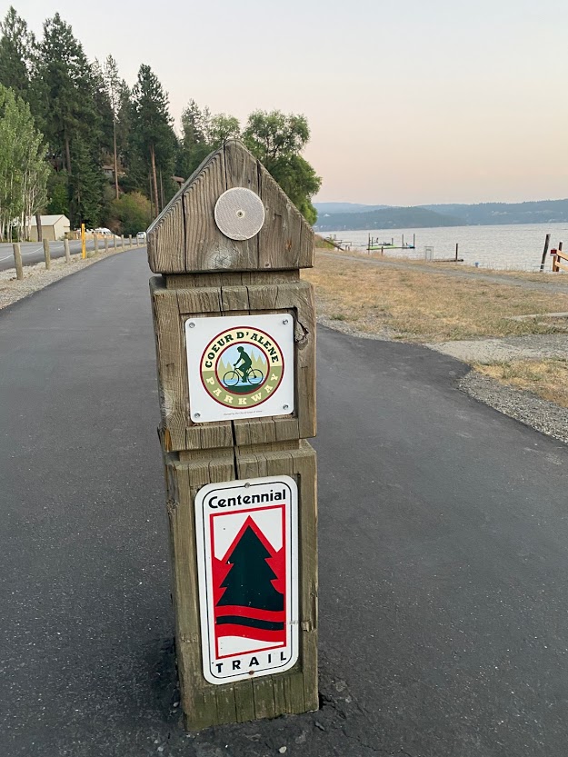 Wood trail sign for Coeur d’Alene Parkway and Centennial Trail.