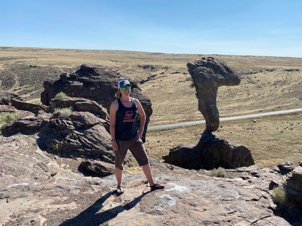 Girl with Balanced Rock in background as part of an Idaho State Parks Challenge