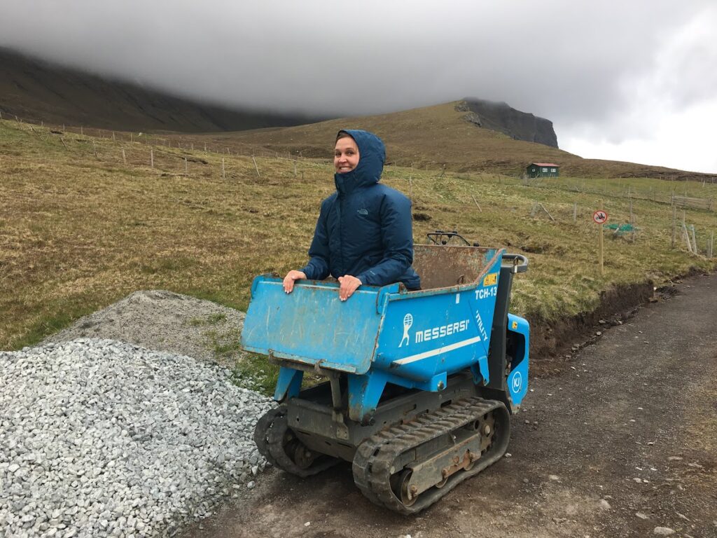Girl in tiny dump truck in the Faroe Islands