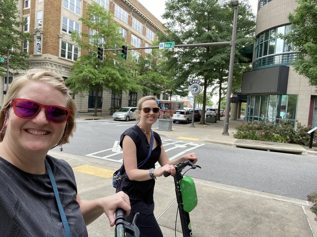 Two friends on scooters in Litte Rock, Arkansas on a digital nomad journey