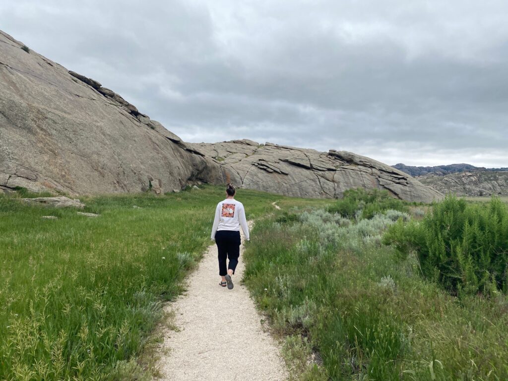 Girl walking around Independence Rock in Wyoming.