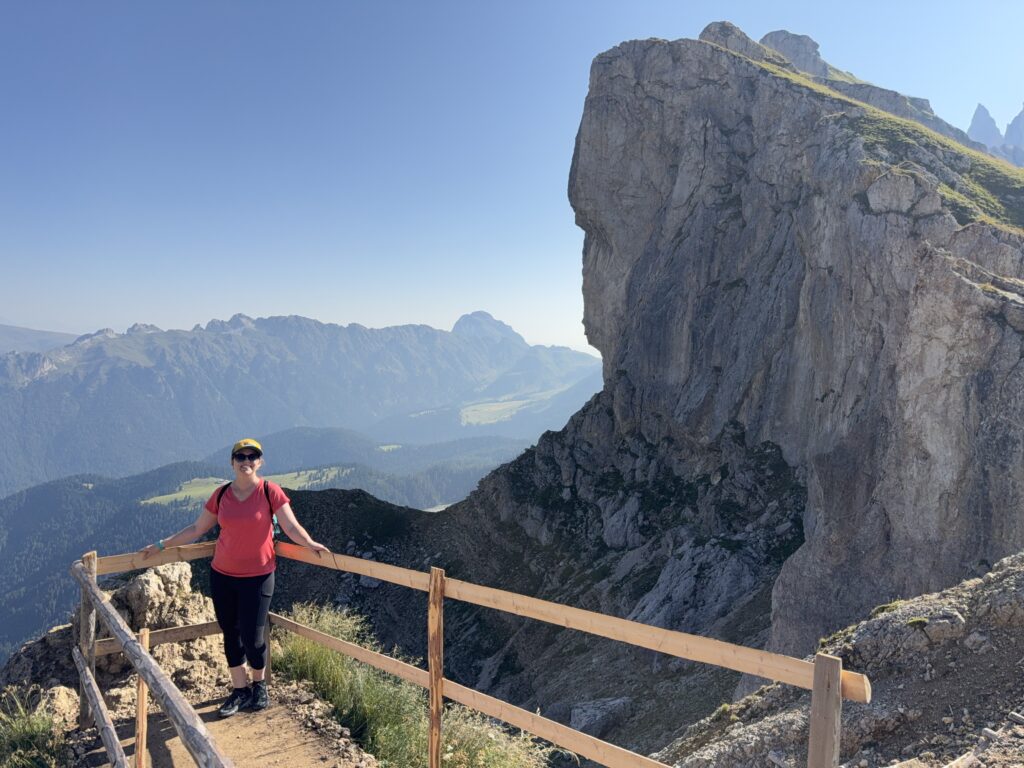 woman in front of mountain cliff