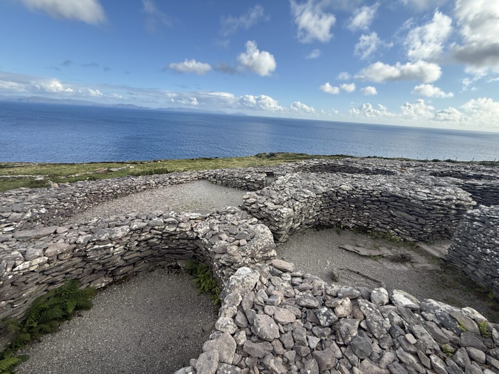stone walls in front of blue ocean