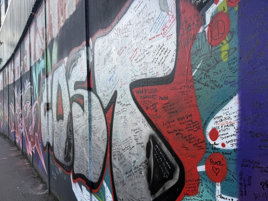 graffiti wall with written notes on it