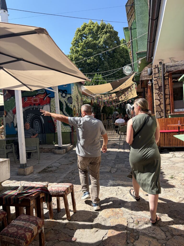 two people walking in front of canopy
