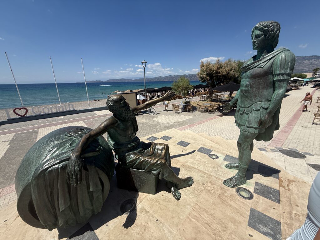 Statue of man on ground and one standing