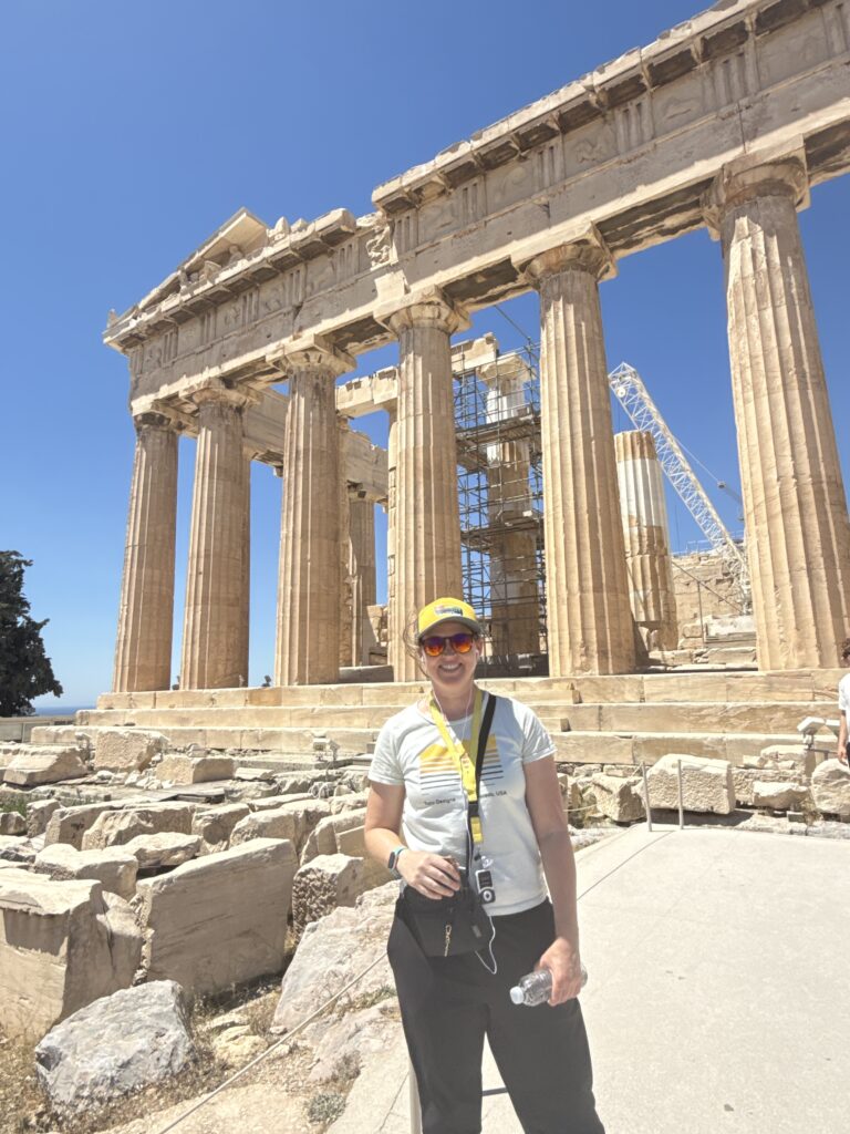 standing in front of stone columns