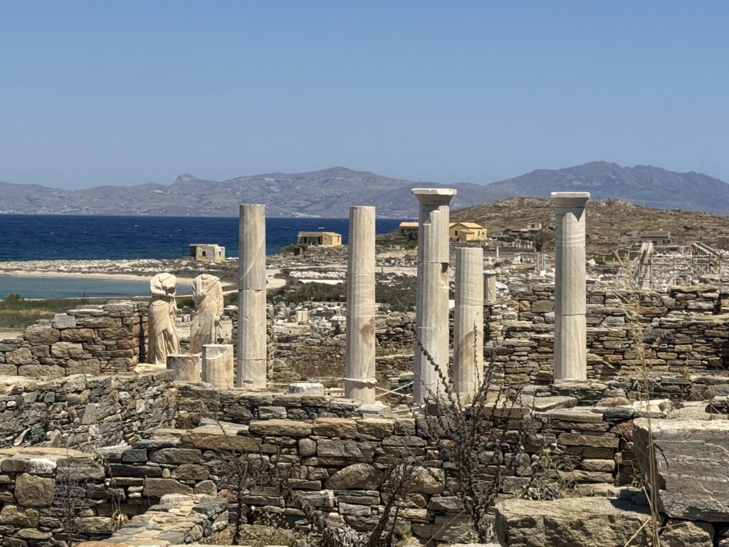 Greek ruins everywhere with the blue sea in the background