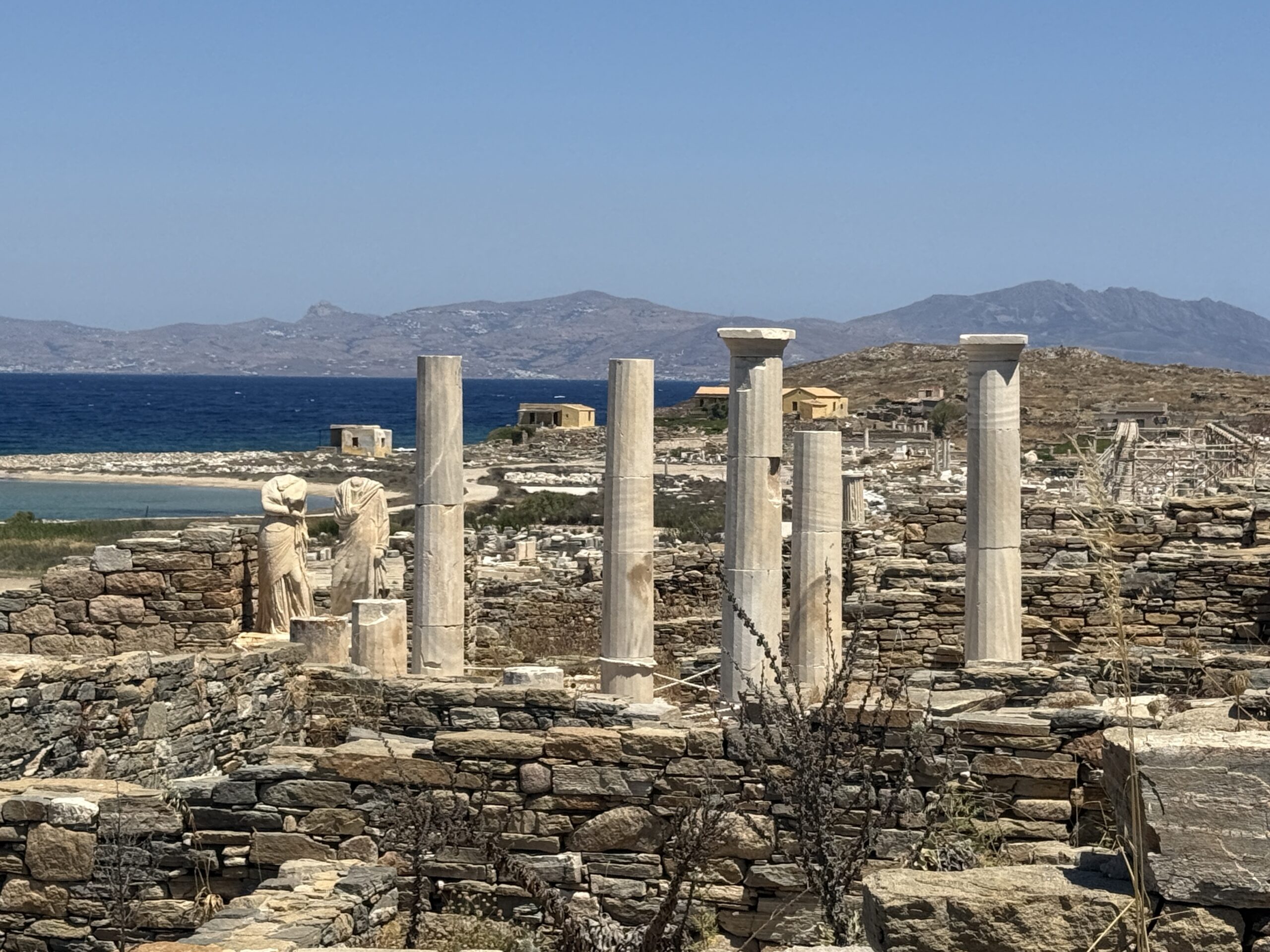 Greek ruins everywhere with the blue sea in the background