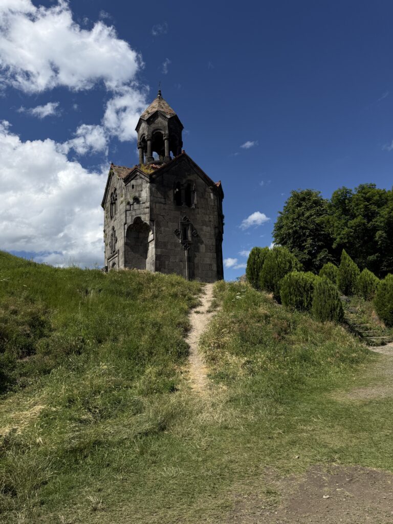 Green hill with stone monastery. 