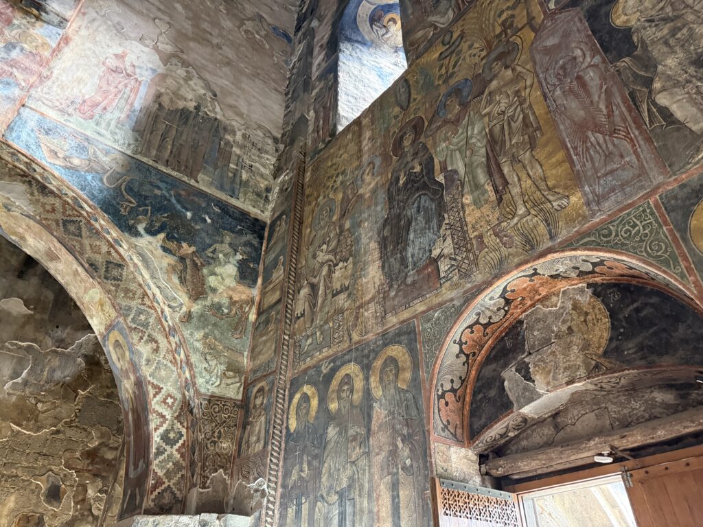 colorful frescoes on a stone wall church