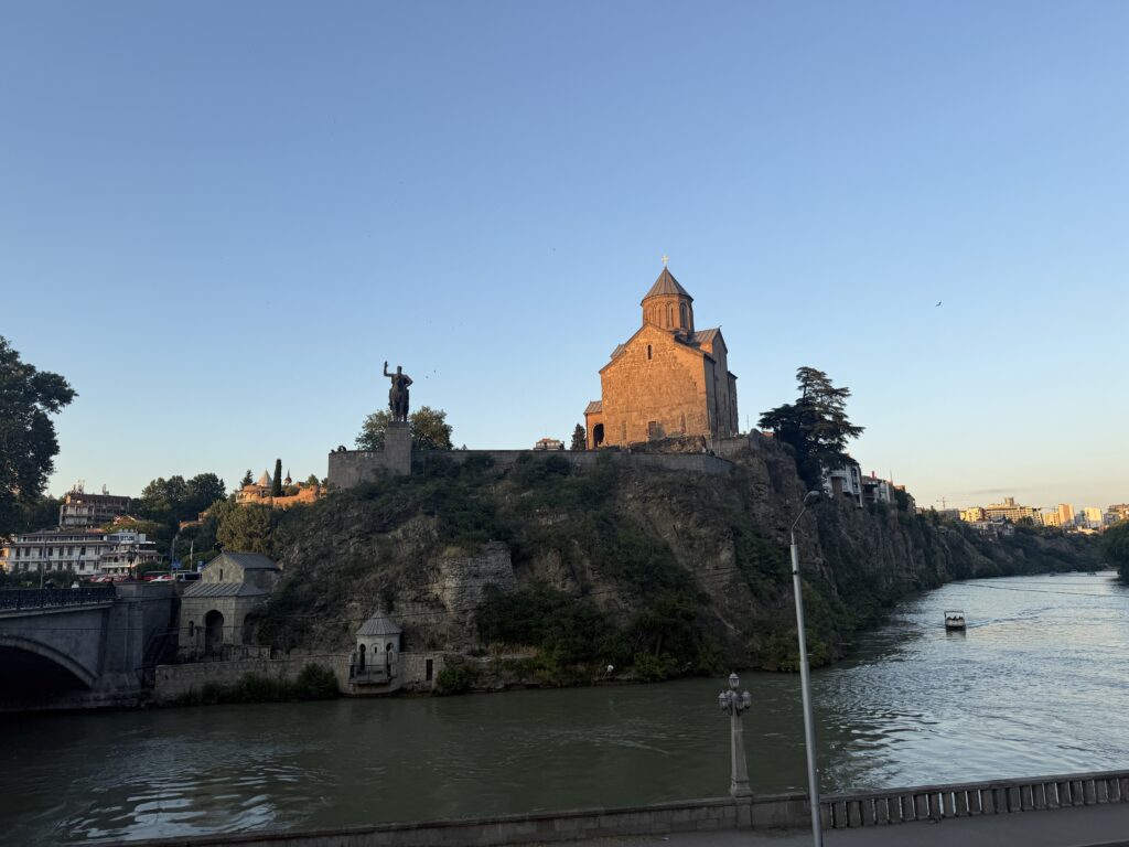 Church on hill in a city next to a river
