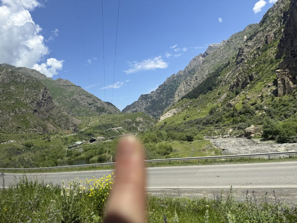 finger pointing to hillside