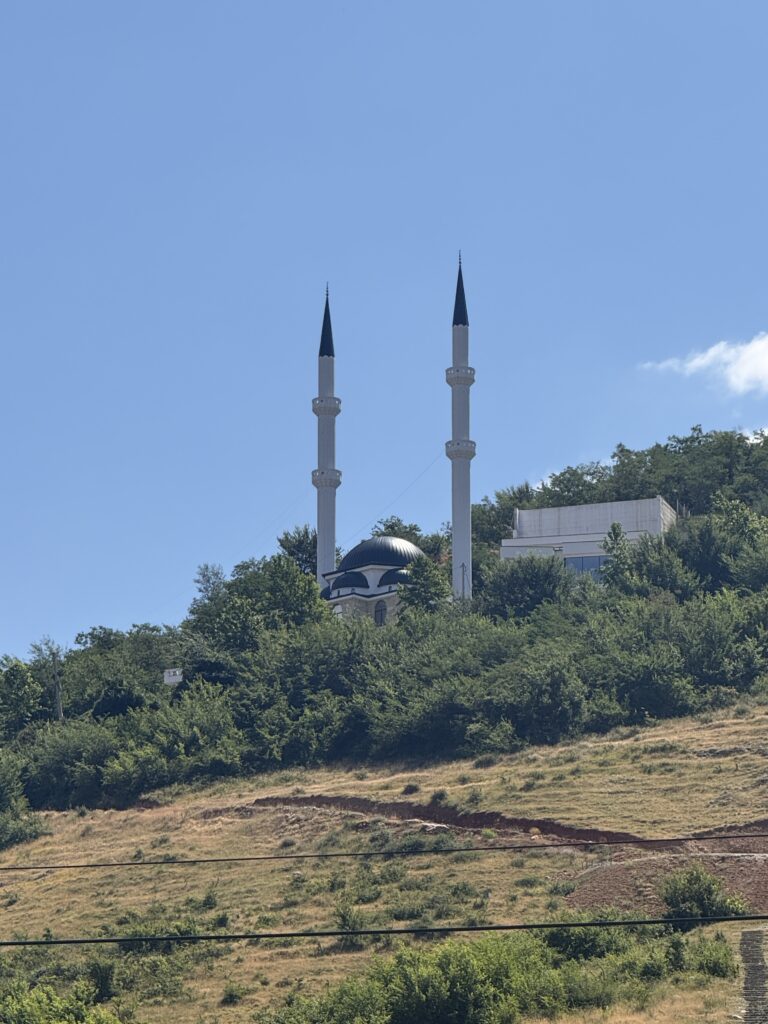 two spired mosque on hill