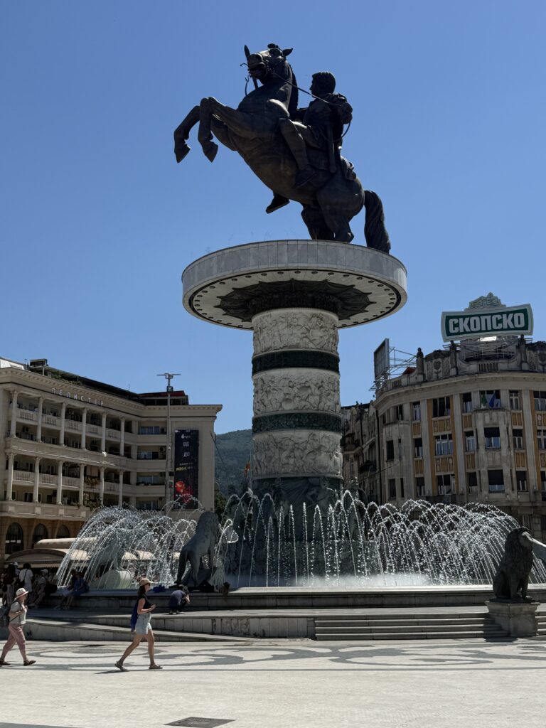 statue of man on horse in front of buildings